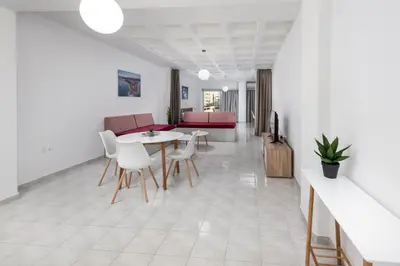a living room with a table and chairs at MV83 new marina in Rhodes Town