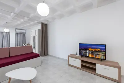 a living room with a couch and a flat screen tv at MV83 new marina in Rhodes Town
