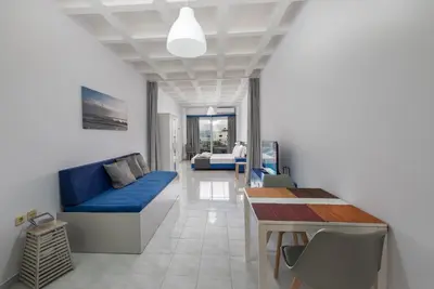 a living room with a blue couch and a table at MV83 new marina in Rhodes Town
