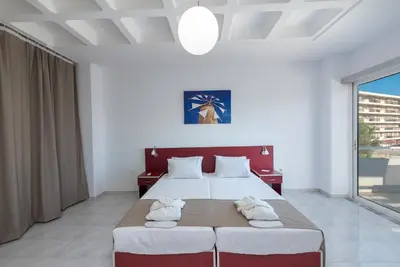 a bedroom with a large bed with towels on it at MV83 new marina in Rhodes Town