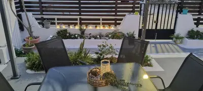 a bird sitting in a basket on a table on a patio at Sweet Home Kremasti in Kremasti