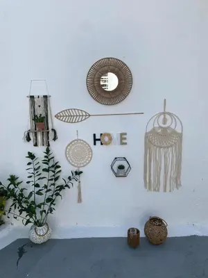 a white wall with various decorations on it with a plant at Sweet Home Kremasti in Kremasti