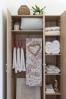 a closet with a heart towel and towels at Sweet Home Kremasti in Kremasti