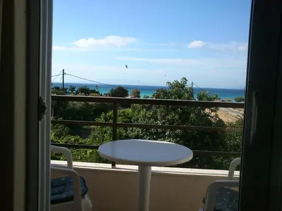 a balcony with a table and a view of the ocean at Kitesurf Paradise Studios in Theologos