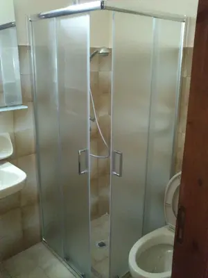 a shower stall in a bathroom with a toilet at Kitesurf Paradise Studios in Theologos