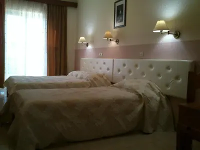 a hotel room with two beds and a window at Kitesurf Paradise Studios in Theologos