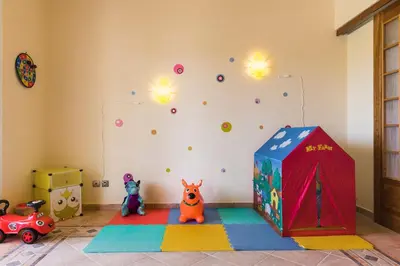 a childs room with a rock wall and toys at Royal Classico Villa in Kolimbia