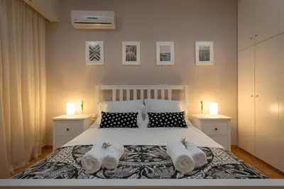 a bedroom with a bed with towels on it at Melita City Apartment in Rhodes Town