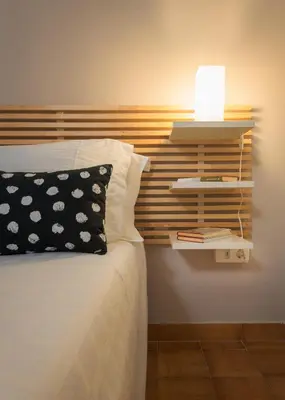 a bedroom with a bed with a lamp on it at Melita City Apartment in Rhodes Town