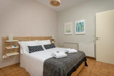 a bedroom with a bed with two towels on it at Melita City Apartment in Rhodes Town