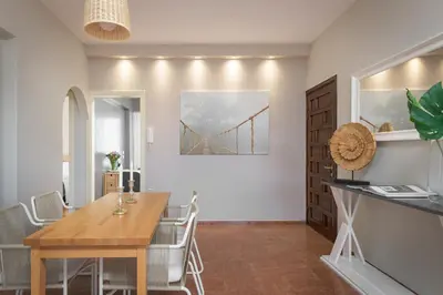 a dining room with a table and a bridge on the wall at Melita City Apartment in Rhodes Town