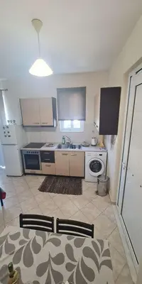 a kitchen with a sink and a stove at Retas apartment in Kremasti