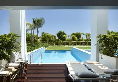 a swimming pool in a house with a patio at Princess Andriana Resort & Spa - Ultra All-Inclusive in Kiotari