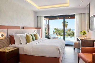a bedroom with a large bed and a balcony at Boutique 5 Hotel & Spa - Adults Only in Kiotari