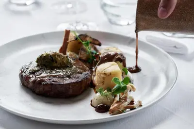 a plate of food with steak and potatoes on a table at Boutique 5 Hotel & Spa - Adults Only in Kiotari