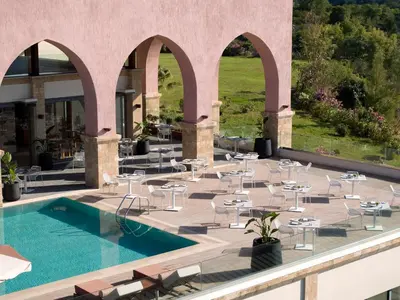 a resort with a pool and tables and chairs at Boutique 5 Hotel & Spa - Adults Only in Kiotari