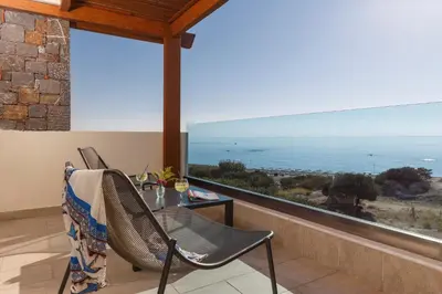 a dining room with a table and a view of the ocean at Boutique 5 Hotel & Spa - Adults Only in Kiotari