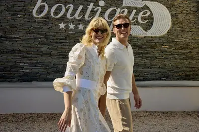a man and a woman standing in front of a building at Boutique 5 Hotel & Spa - Adults Only in Kiotari