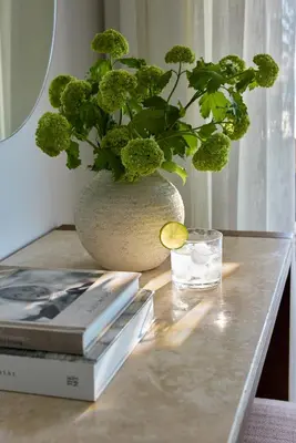 a vase with a plant on a table with books at Boutique 5 Hotel & Spa - Adults Only in Kiotari