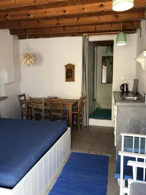 a kitchen and dining room with a table and chairs at Plesner House, Symi Greece in Symi