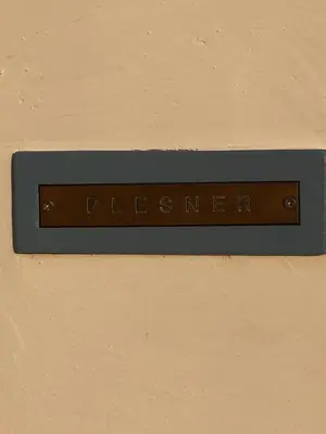 a sign on a wall that reads pierce istg at Plesner House, Symi Greece in Symi