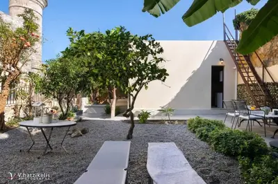 a courtyard with a table and a tree at Aramis Boutique House in Rhodes Town