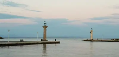 a statue in the middle of the water on a pier at Aramis Boutique House in Rhodes Town