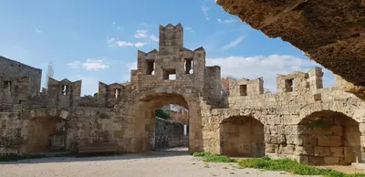 an old castle with two arches and a fence at Aramis Boutique House in Rhodes Town