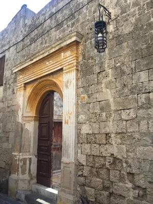 an entrance to a brick building with a wooden door at Aramis Boutique House in Rhodes Town