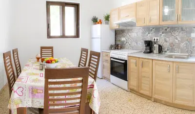 a kitchen with a table with chairs and a sink at Aramis Boutique House in Rhodes Town
