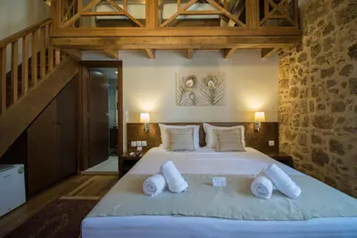 a bedroom with a large bed with white pillows at D'Argento Boutique Rooms in Rhodes Town