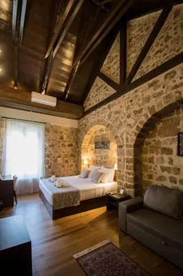 a bedroom with a bed and a brick wall at D'Argento Boutique Rooms in Rhodes Town