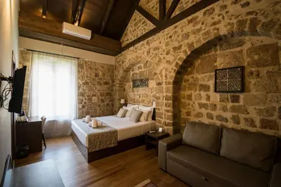 a bedroom with a bed and a brick wall at D'Argento Boutique Rooms in Rhodes Town