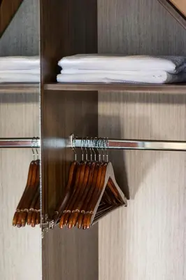 a glass shelf with wooden hangers in a room at D'Argento Boutique Rooms in Rhodes Town