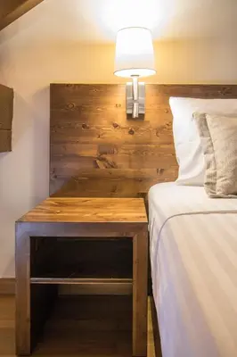 a bed and a table with a lamp next to a bed at D'Argento Boutique Rooms in Rhodes Town