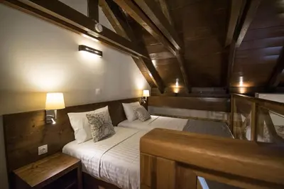 a bedroom with two beds in a room with wooden ceilings at D'Argento Boutique Rooms in Rhodes Town