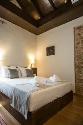 a bedroom with a large bed with towels on it at D'Argento Boutique Rooms in Rhodes Town