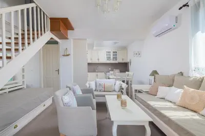 a living room with a couch and a table at Aegli Villa by Blue Wave in Symi