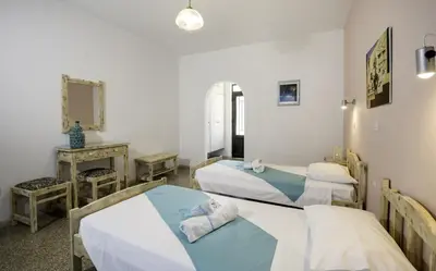 a hospital room with two beds and a mirror at Kalathos Sun Hotel in Kalathos