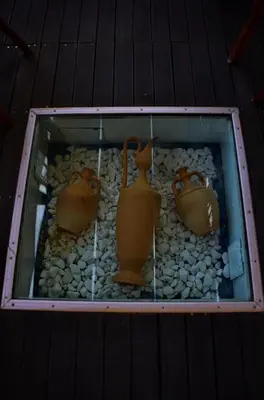 a display of three vases and rocks on a table at Kalathos Sun Hotel in Kalathos