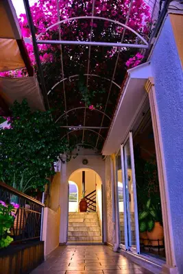 a hallway with pink flowers on the ceiling of a building at Kalathos Sun Hotel in Kalathos