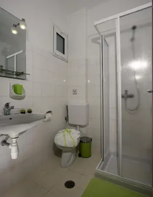 a bathroom with a toilet and a shower and a sink at Kalathos Sun Hotel in Kalathos