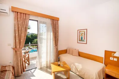 a bedroom with a bed and a window with a view at Stavros Melathron Studios in Kallithea Rhodes