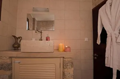 a bathroom with a sink and a mirror at Arionos Rooms - Old Town in Rhodes Town