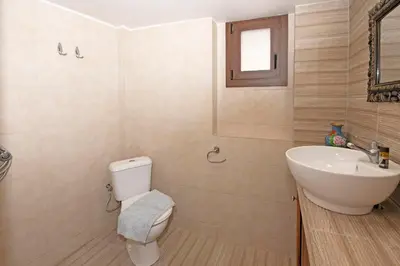 a bathroom with a toilet and a sink at Arionos Rooms - Old Town in Rhodes Town
