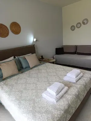 a bedroom with a bed with towels on it at Agathi Paradise Studios in Haraki