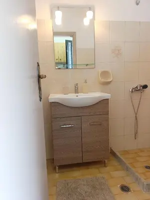 a bathroom with a sink and a mirror at Agathi Paradise Studios in Haraki
