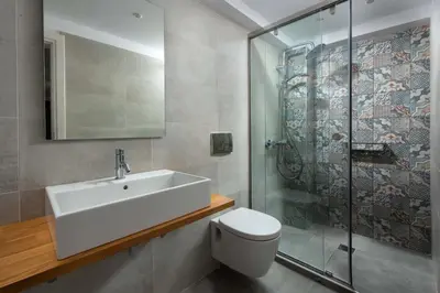 a bathroom with a sink and a toilet and a shower at Lindos Heart Apartments in Líndos
