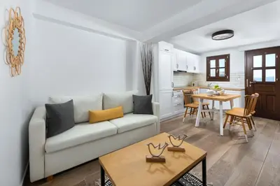 a living room with a couch and a table at Lindos Heart Apartments in Líndos