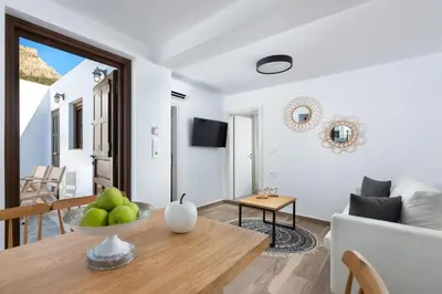a living room with a table and a couch at Lindos Heart Apartments in Líndos